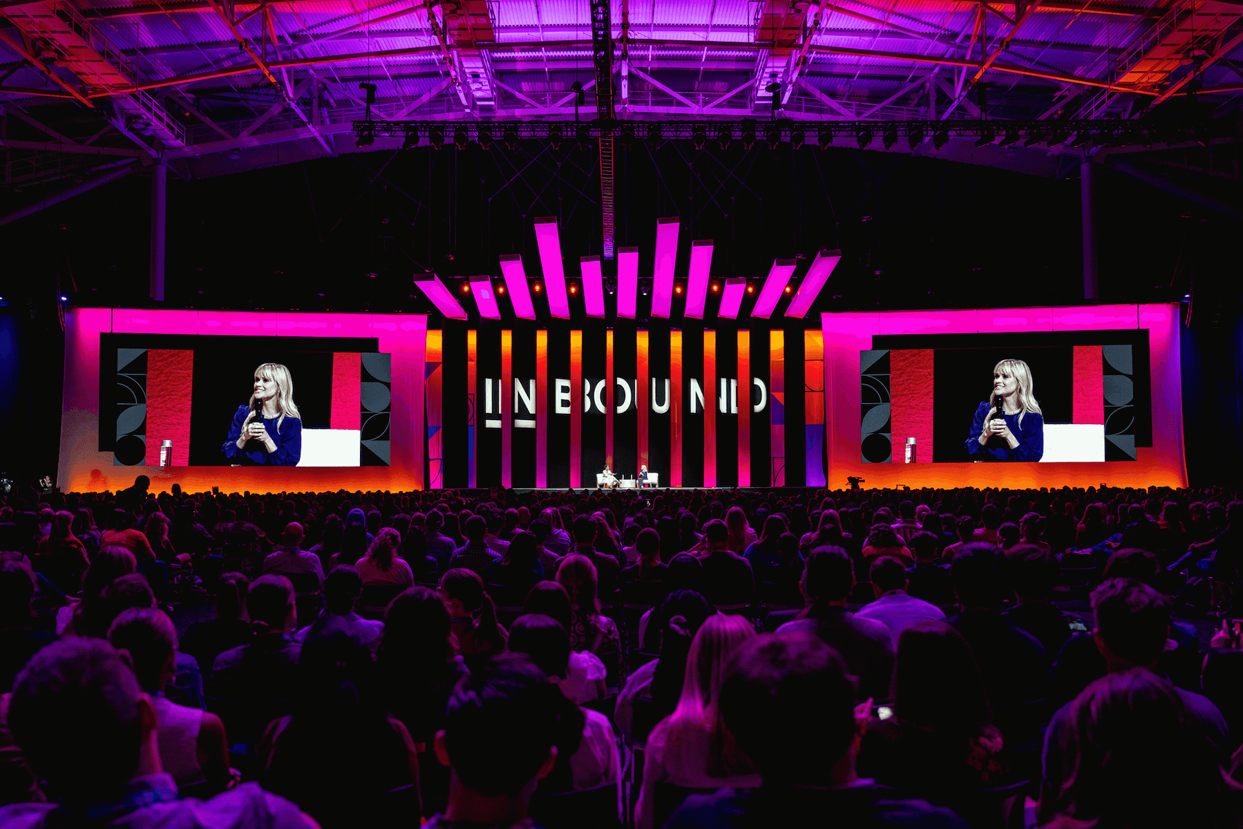 HubSpot INBOUND conference main stage illuminated in magenta and orange