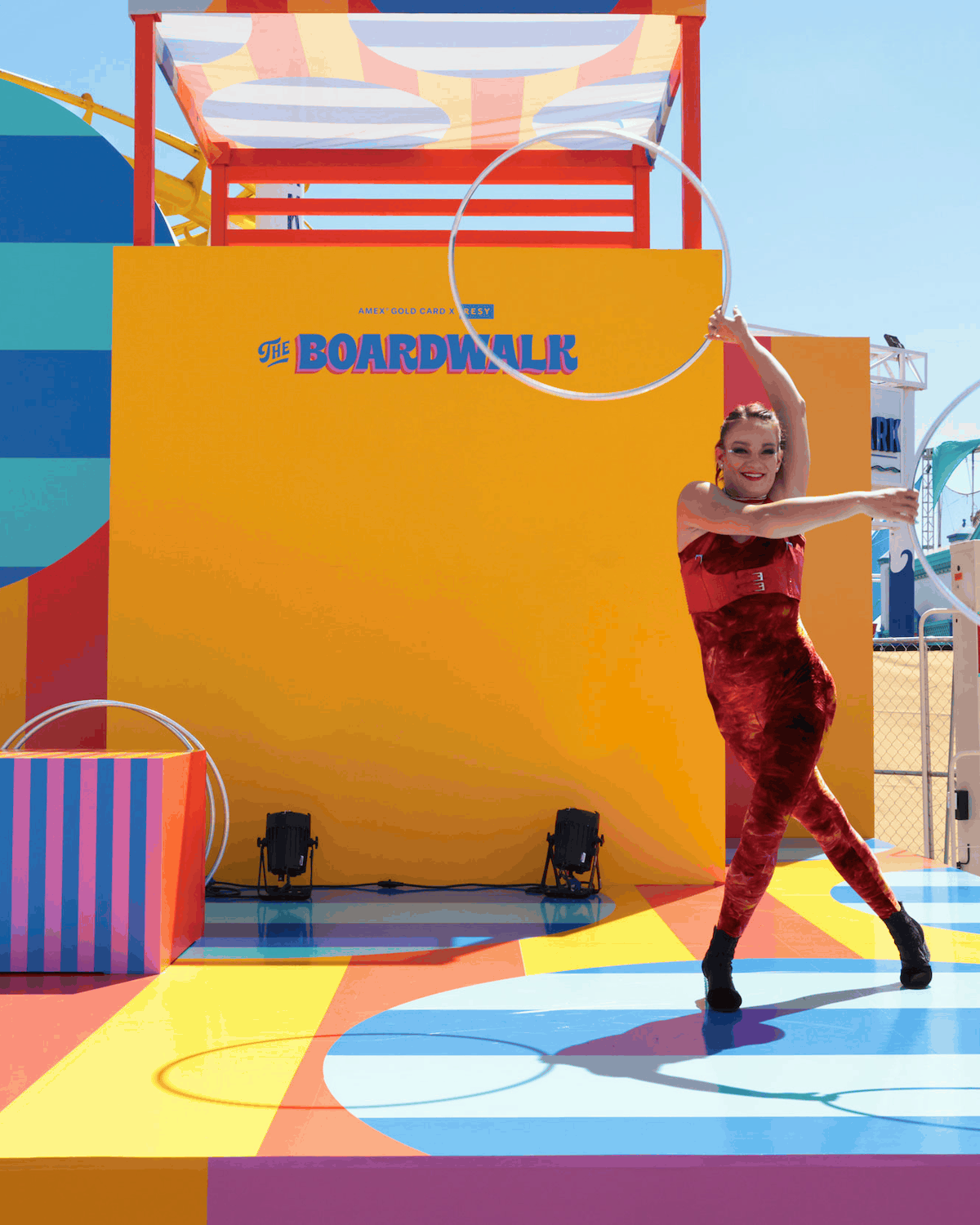Performer with a hoop at the colorful Resy and American Express Boardwalk event