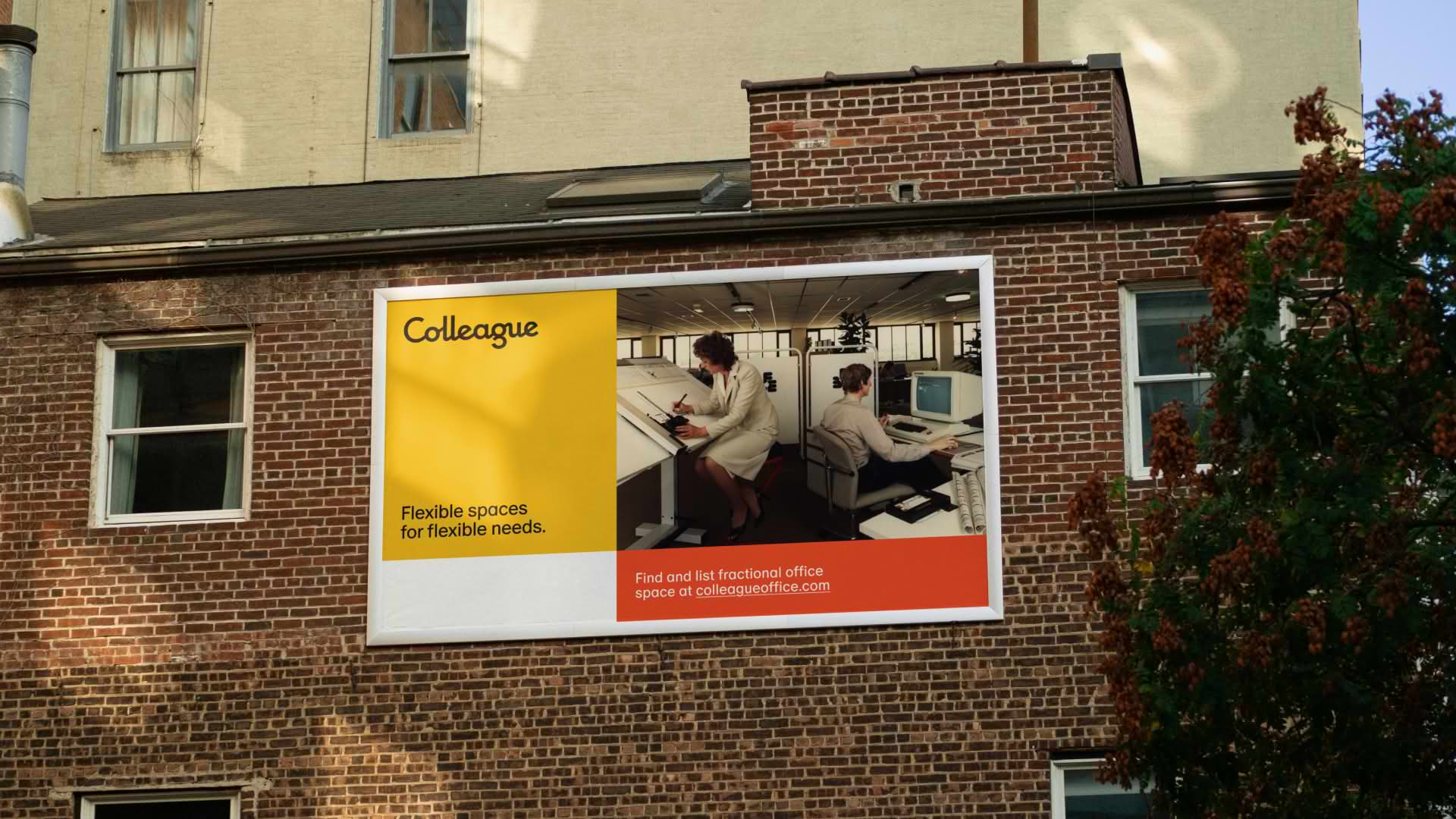 Colleague campaign posters installed on a brick building