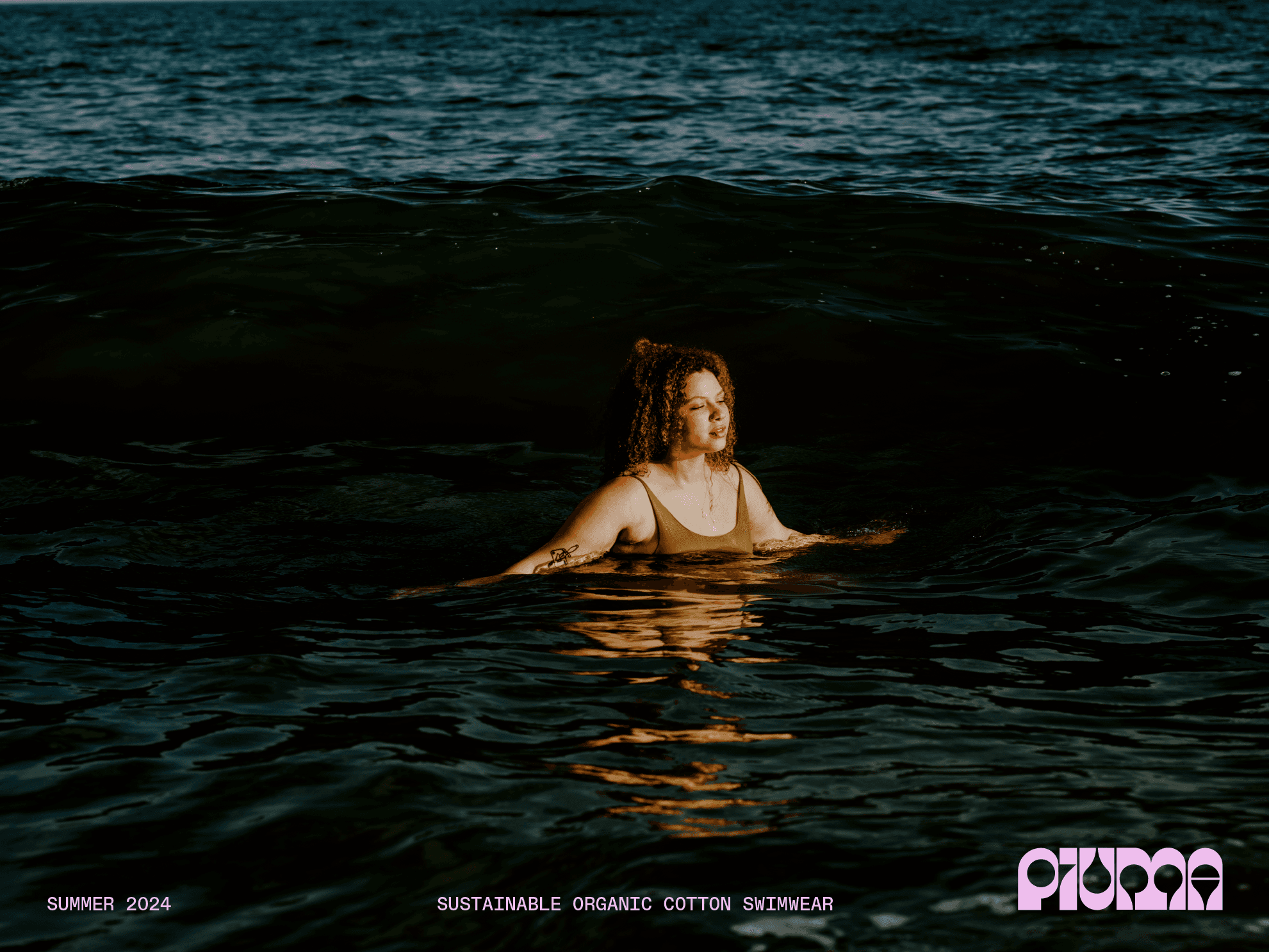 Piuma sustainable swimwear campaign featuring a model in the ocean